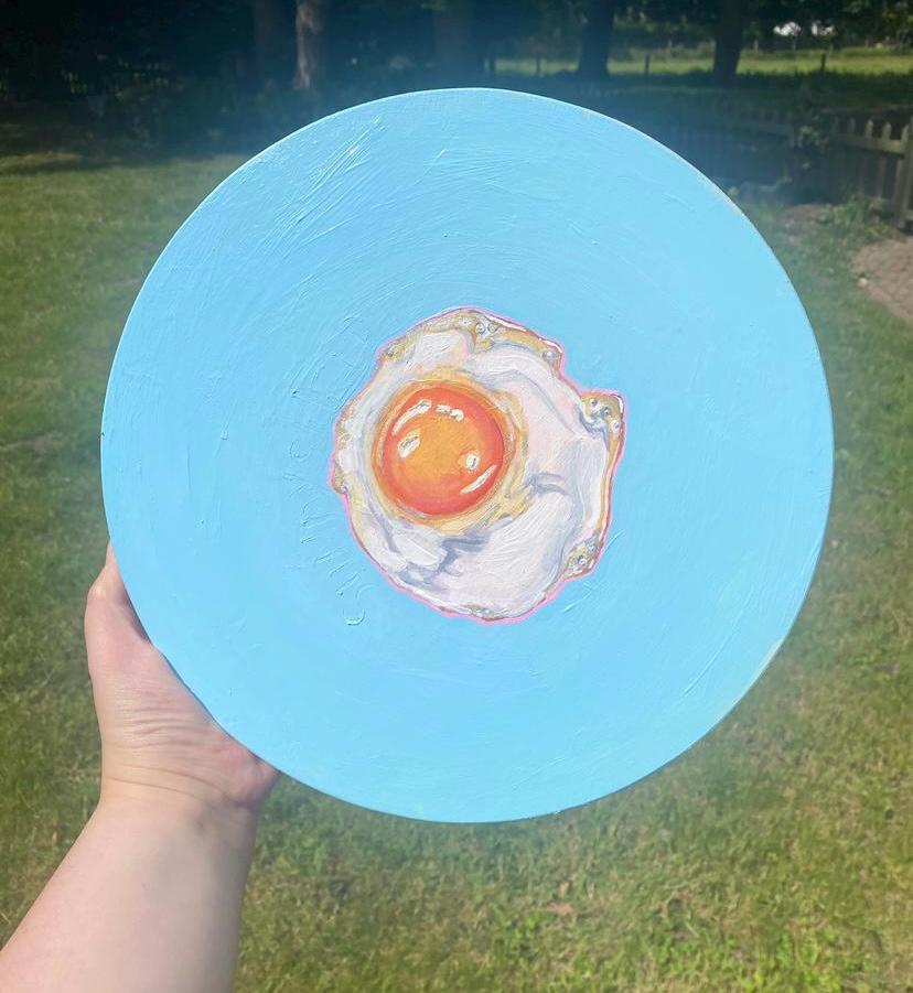 Sunny side up, acrylic fried egg painting on wooden panel.