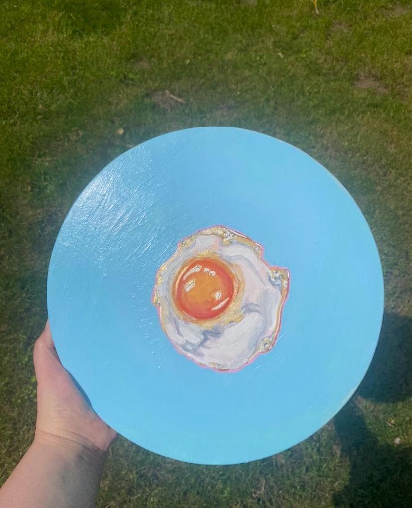 Sunny side up, acrylic fried egg painting on wooden panel.